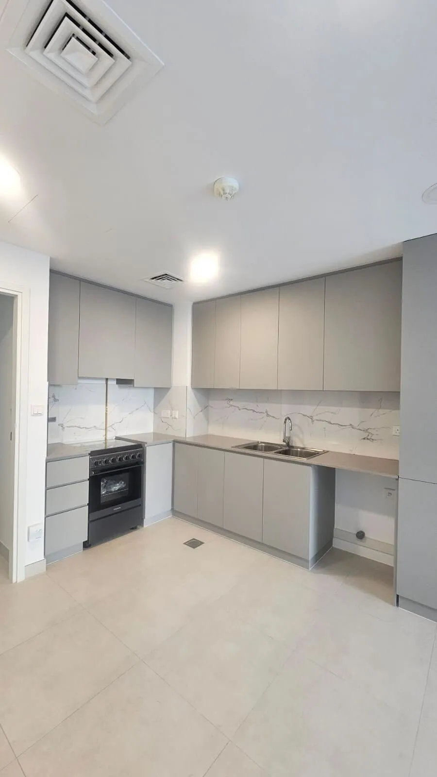 Grey cabinets with marble effect backsplash Dubai