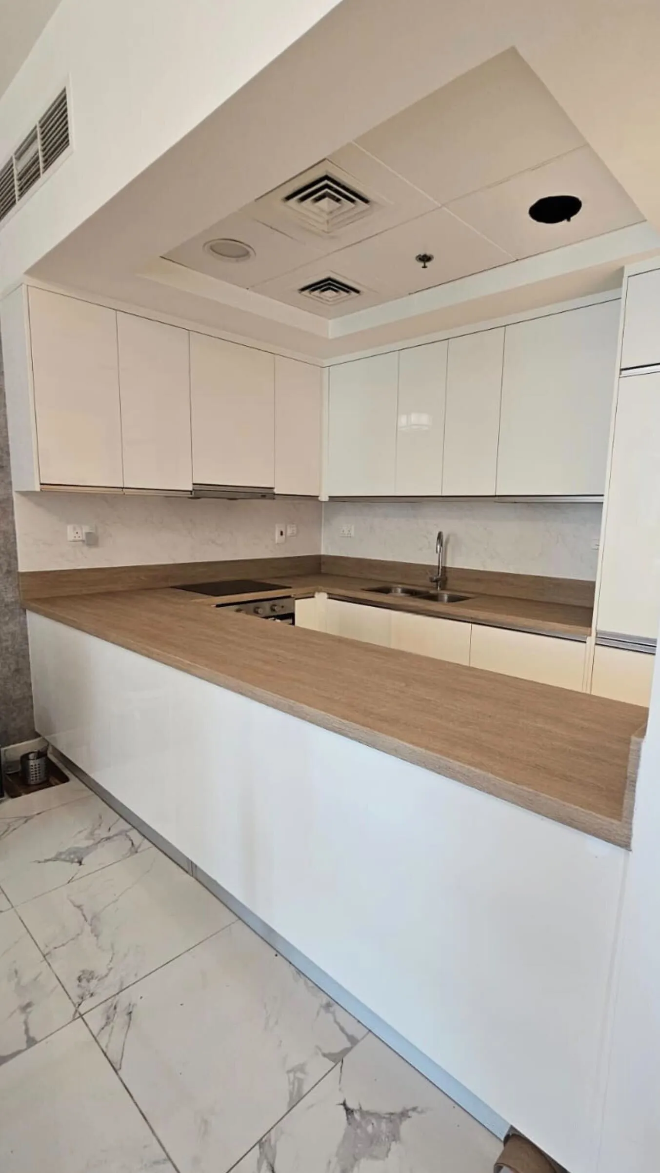 White cabinets with natural wood countertop wrap