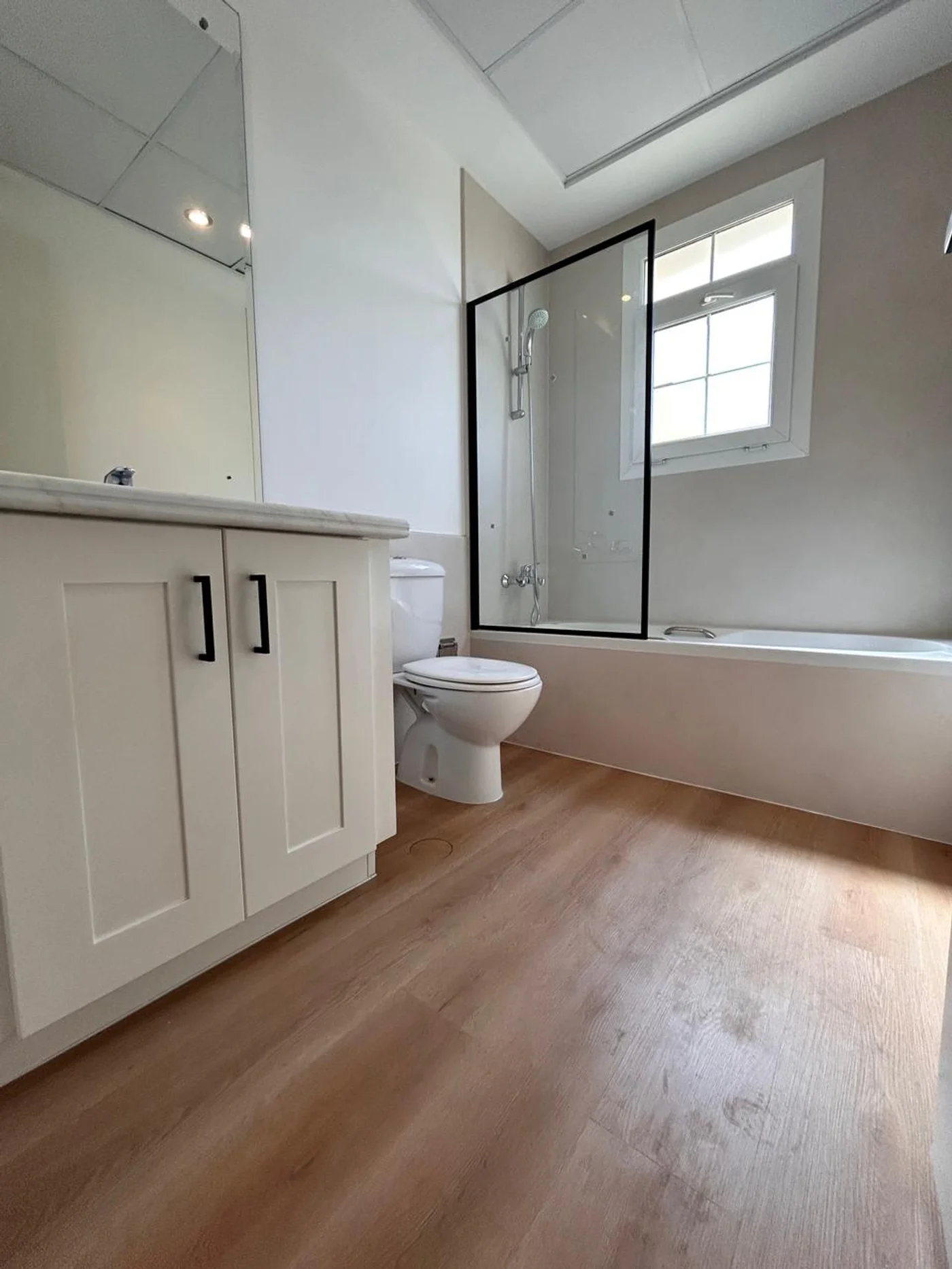 White bathroom with wood floor vinyl wrap - Arabian Ranches Dubai