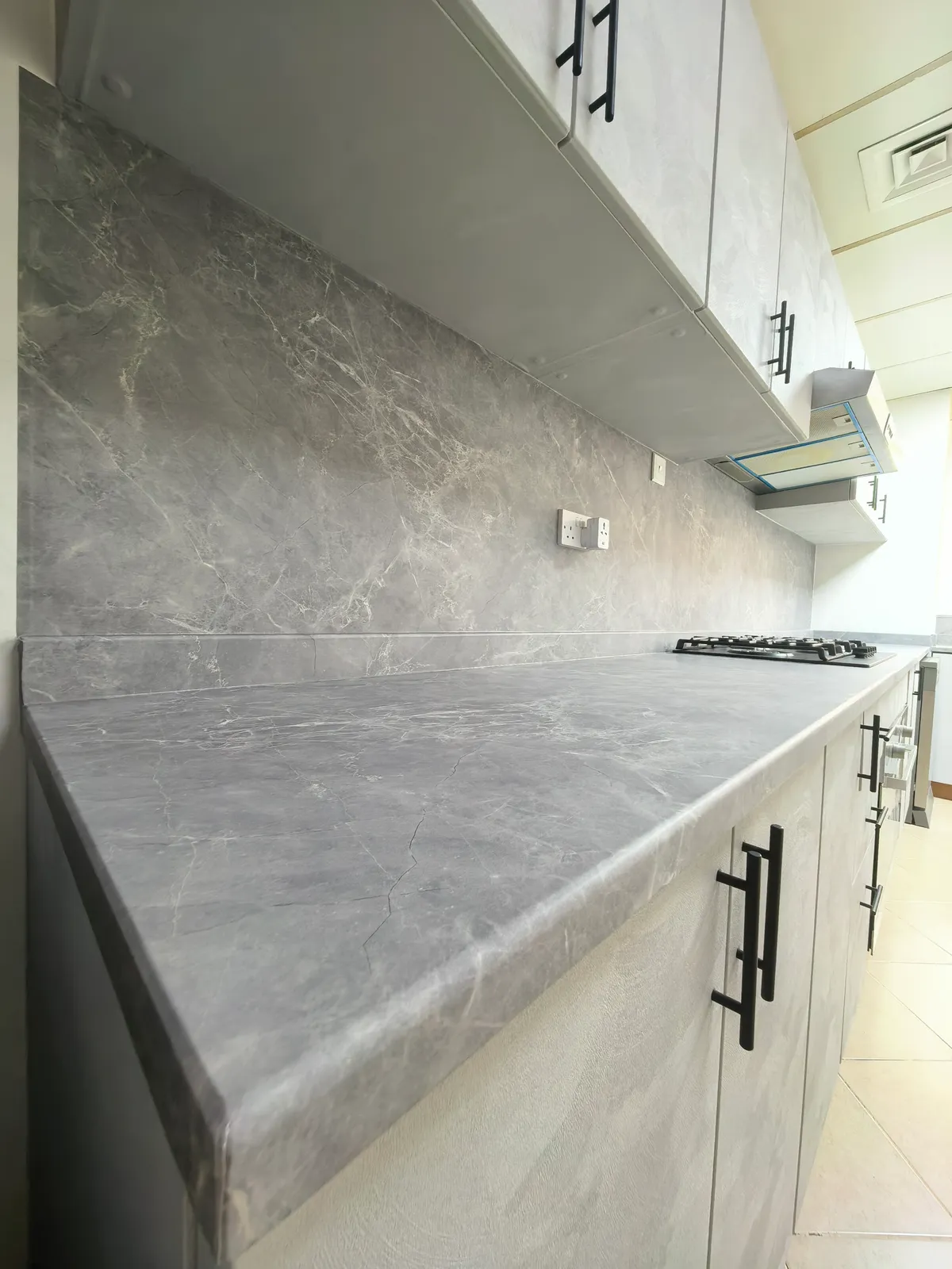 Grey marble countertop and backsplash vinyl wrap Dubai kitchen