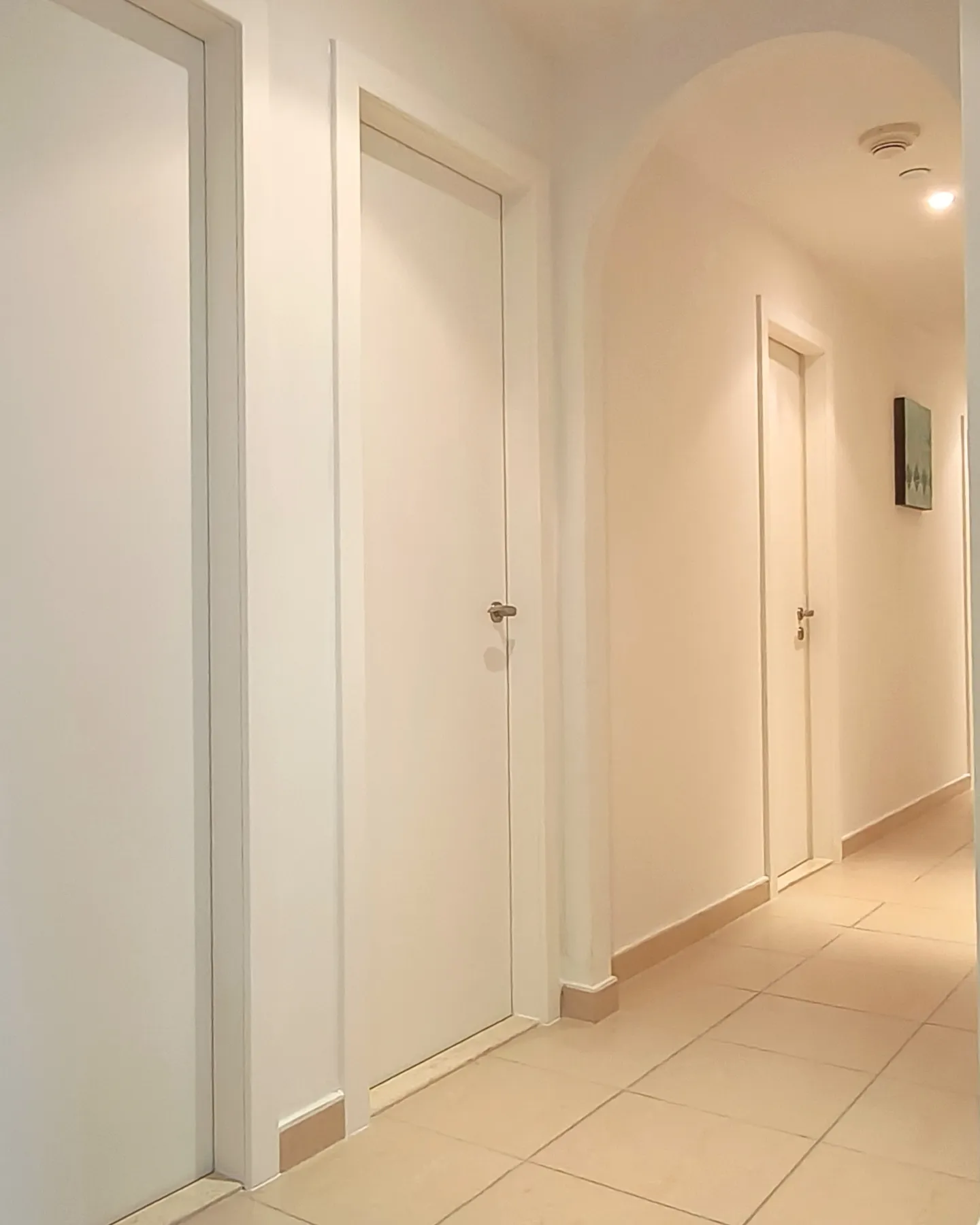 Apartment hallway doors wrapped in white vinyl Dubai