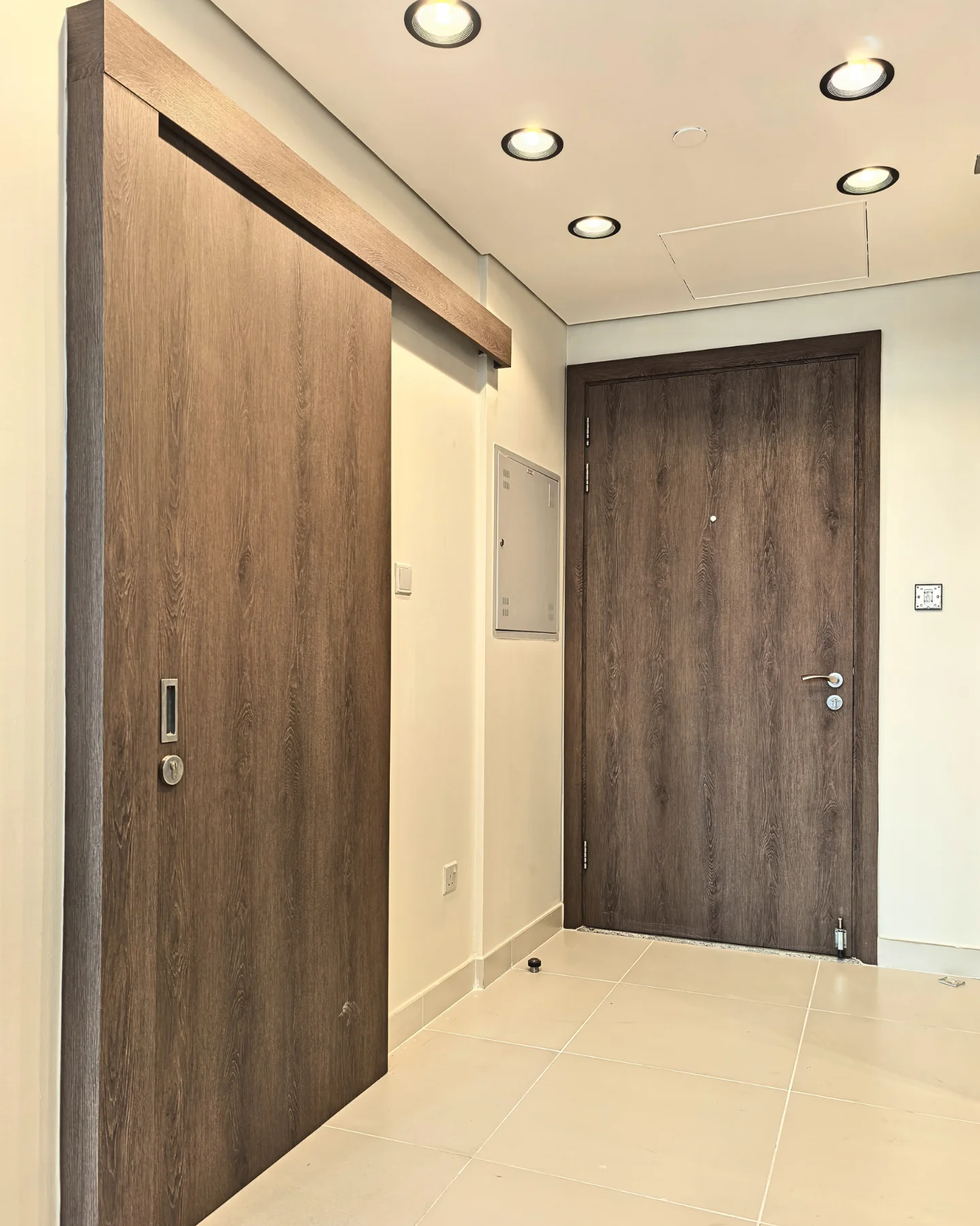 Dark walnut sliding and hinged doors wrapped in vinyl Dubai